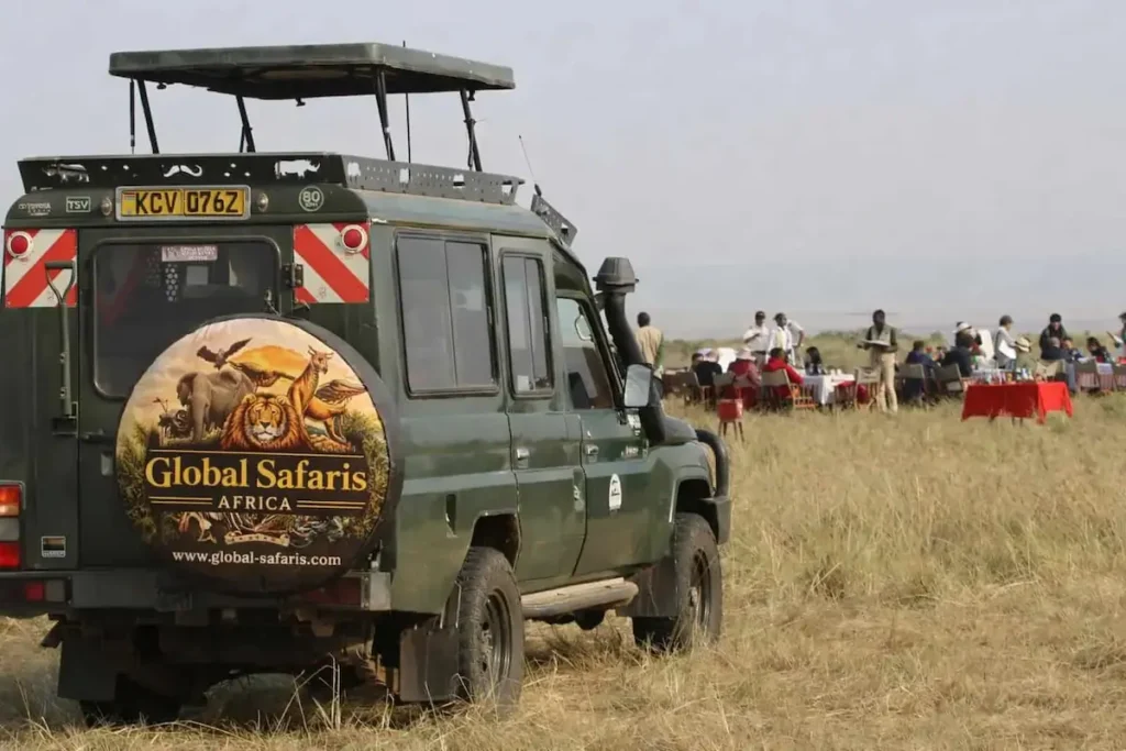 Pop-roof 4x4 Land Cruiser on a budget group joining safari in Masai Mara Kenya